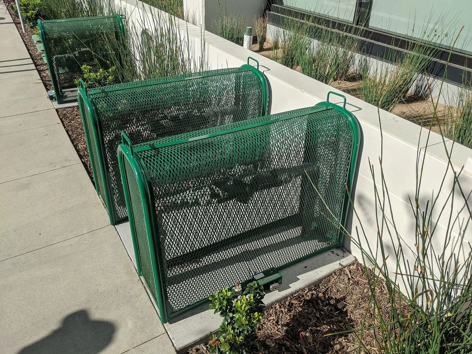 A backflow preventer in a protective cage in front of a residential building
